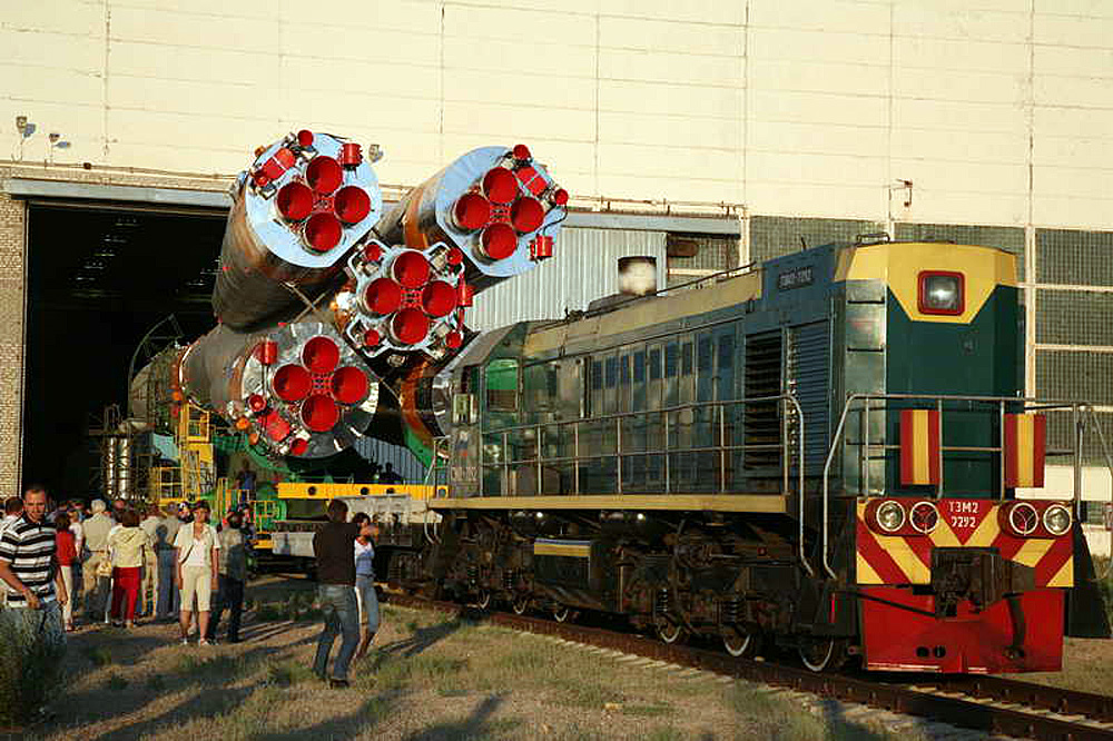 Bajkonur - motorová lokomotiva TEM2 vytahuje raketu s kosmickou lodí TMA3 z montážní haly