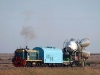 Bajkonur - ostře sledovaný vlak v čele s lokomotivou TEM2. V tomto úsek jede souprava špičkou rakety ve směru jízdy